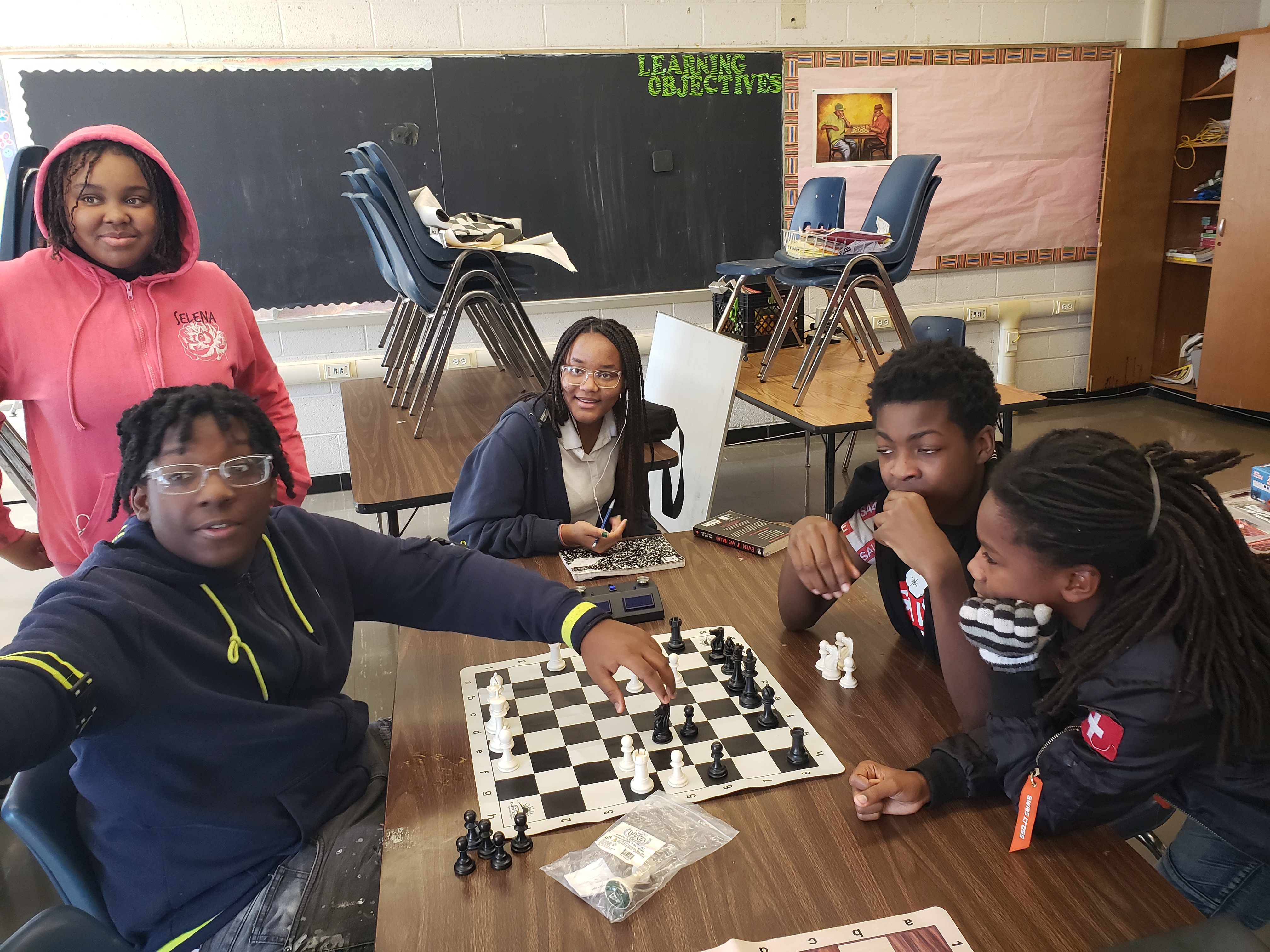Students take a break from chess practice to pose for a picture